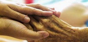 Photo of caring hands holding