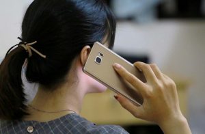 Woman holding cell phone to ear